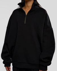 Woman wearing AfterDark ZeroCrease Quarter Zip - Black | Model:Loren | Size:XS