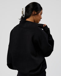 Woman wearing AfterDark ZeroCrease Quarter Zip - Black | Model:Loren | Size:XS