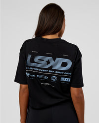 Woman wearing Archive FLXCotton Oversized Tee - Black-Open Air | Model:Kirstyn | Size:XS