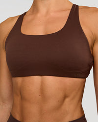Woman wearing Aspire Sports Bra - Hot Chocolate | Model:Maja | Size:XS