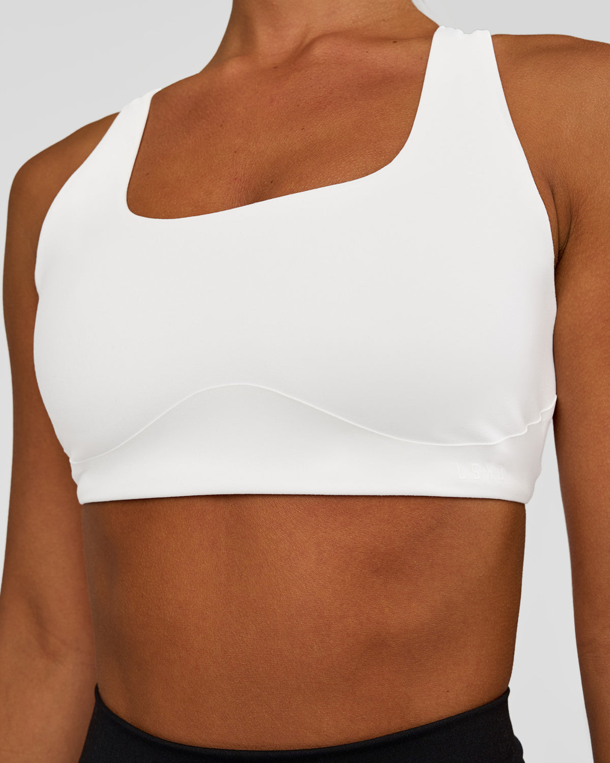Woman wearing Aspire Sports Bra - White | Model:Brylee | Size:XS - view 1
