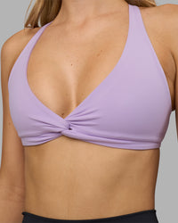 Woman wearing Aspire Twist Sports Bra - Pale Lilac | Model:Leilani | Size:XS