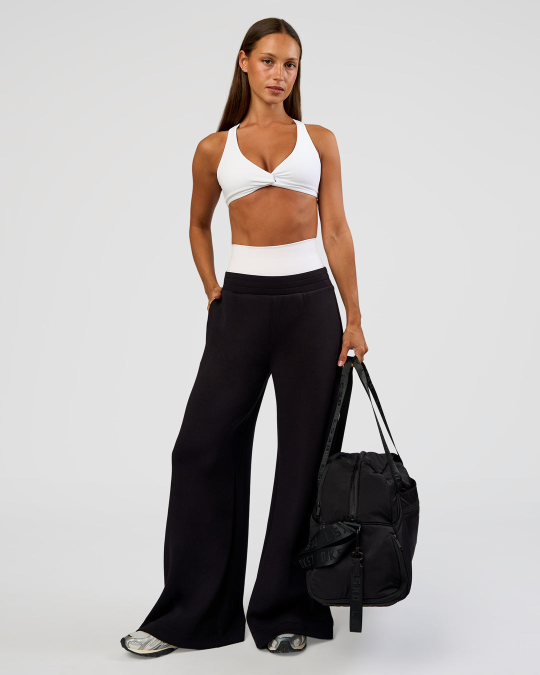 Woman wearing Aspire Twist Sports Bra - White | Model:Brylee | Size:XS - view 3