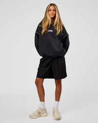 Woman wearing Axis Oversized Hoodie - Caviar-White | Model:Georgia | Size:XS