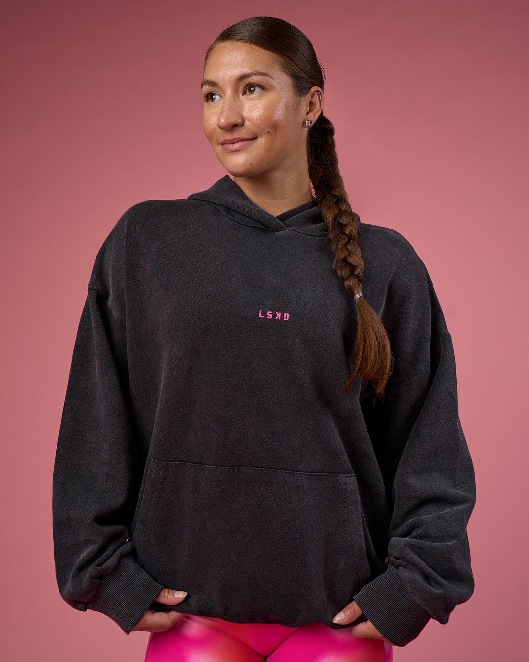 Woman wearing BCAM Washed Unisex Oversized Hoodie - Black Washed-Pink | Model:Hannah | Size:XS