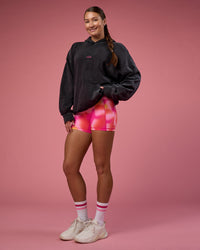 Woman wearing BCAM Washed Unisex Oversized Hoodie - Black Washed-Pink | Model:Hannah | Size:XS