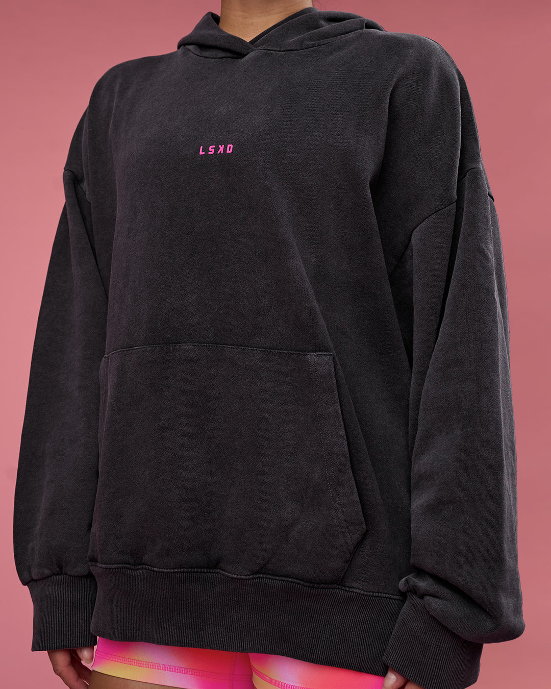 Woman wearing BCAM Washed Unisex Oversized Hoodie - Black Washed-Pink | Model:Hannah | Size:XS