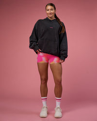 Woman wearing BCAM Washed Unisex Oversized Hoodie - Black Washed-Pink | Model:Hannah | Size:XS