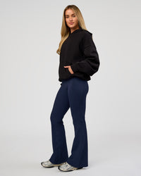 Woman wearing Base Oversized Hoodie - Black | Model:Issy | Size:XS |