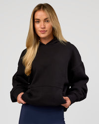 Woman wearing Base Oversized Hoodie - Black | Model:Issy | Size:XS |