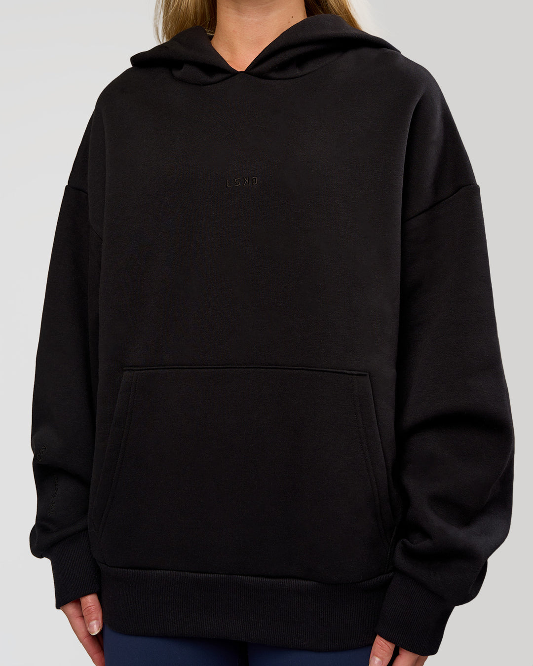 Woman wearing Base Oversized Hoodie - Black | Model:Issy | Size:XS |