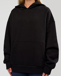Woman wearing Base Oversized Hoodie - Black | Model:Issy | Size:XS |