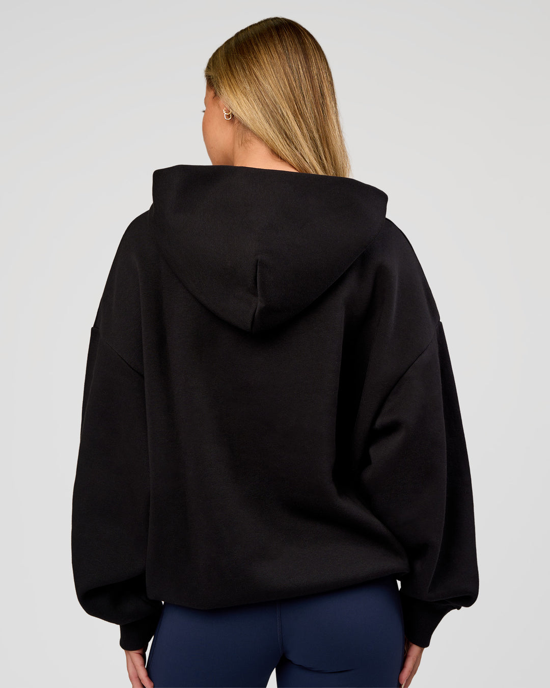 Woman wearing Base Oversized Hoodie - Black | Model:Issy | Size:XS |