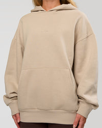 Woman wearing Base Oversized Hoodie - Shale Beige | Model:Issy | Size: XS |