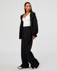 Woman wearing Base Zip Through Oversized Hoodie - Black | Model:Brylee | Size:XS