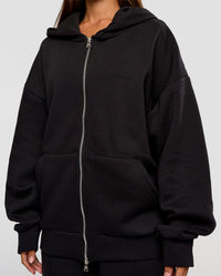 Woman wearing Base Zip Through Oversized Hoodie - Black | Model:Brylee | Size:XS