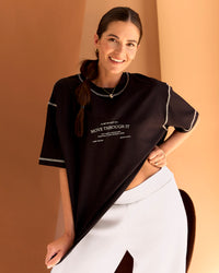 Woman wearing CF Unisex Oversized Heavyweight FLXCotton Tee - Black-CF Move Through It | Model:Chloe | Size:XS