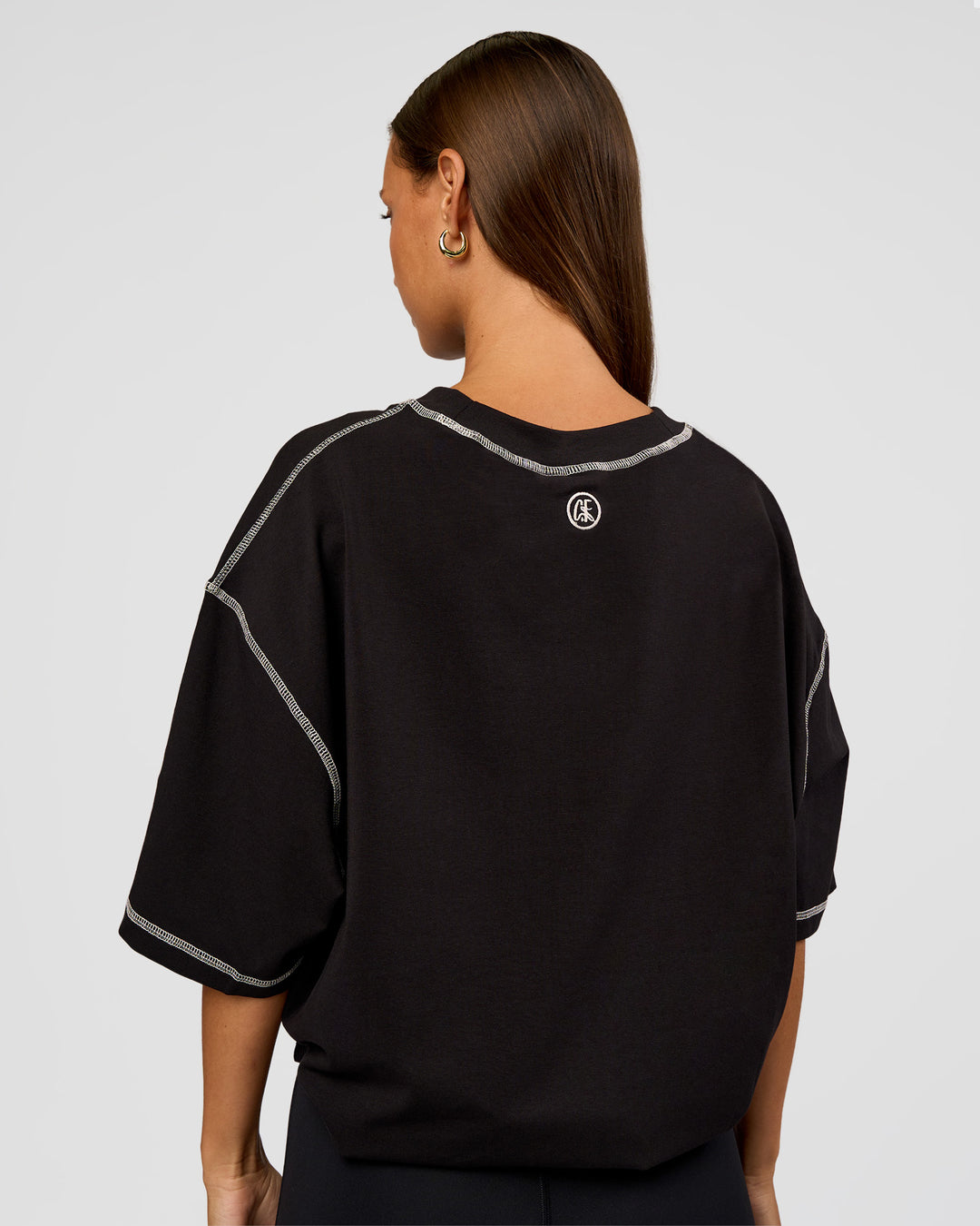 Woman wearing CF Unisex Oversized Heavyweight FLXCotton Tee - Black-CF Move Through It | Model:Brylee | Size:XS