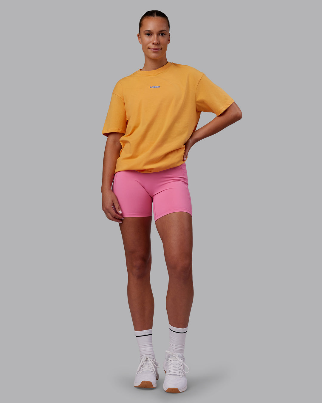 Woman wearing CFT BNE 25 FLXCotton Oversized Tee - Warm Apricot-Purple Opulence | Model:Charlize | Size:XS