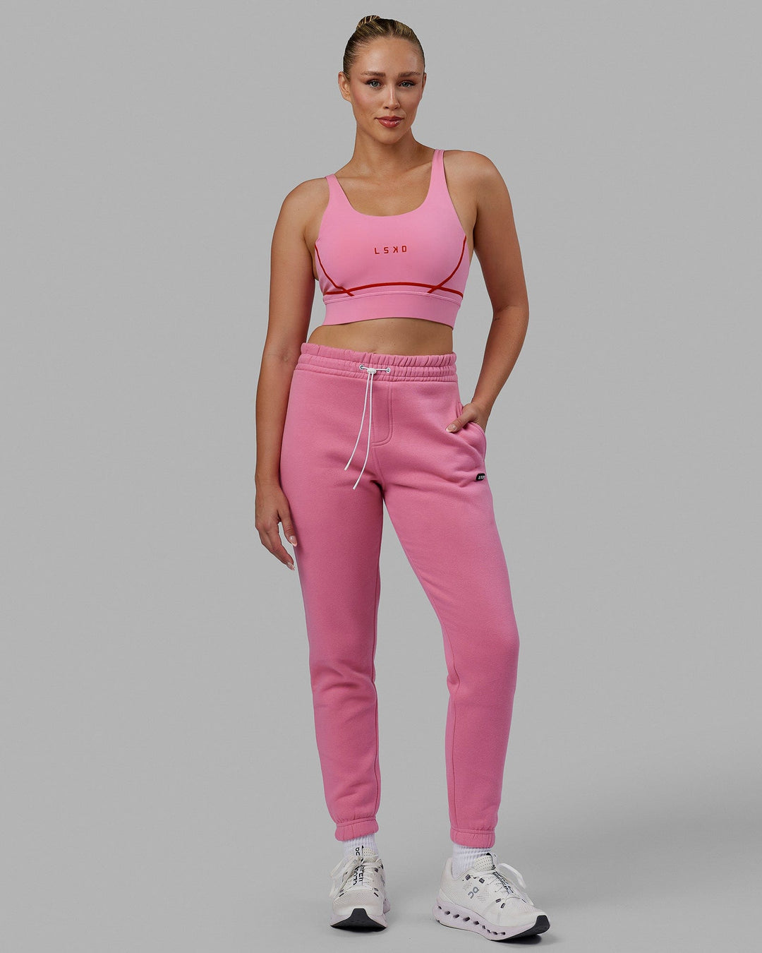 Woman wearing Unisex Capsule Track Pants - Pink Rose