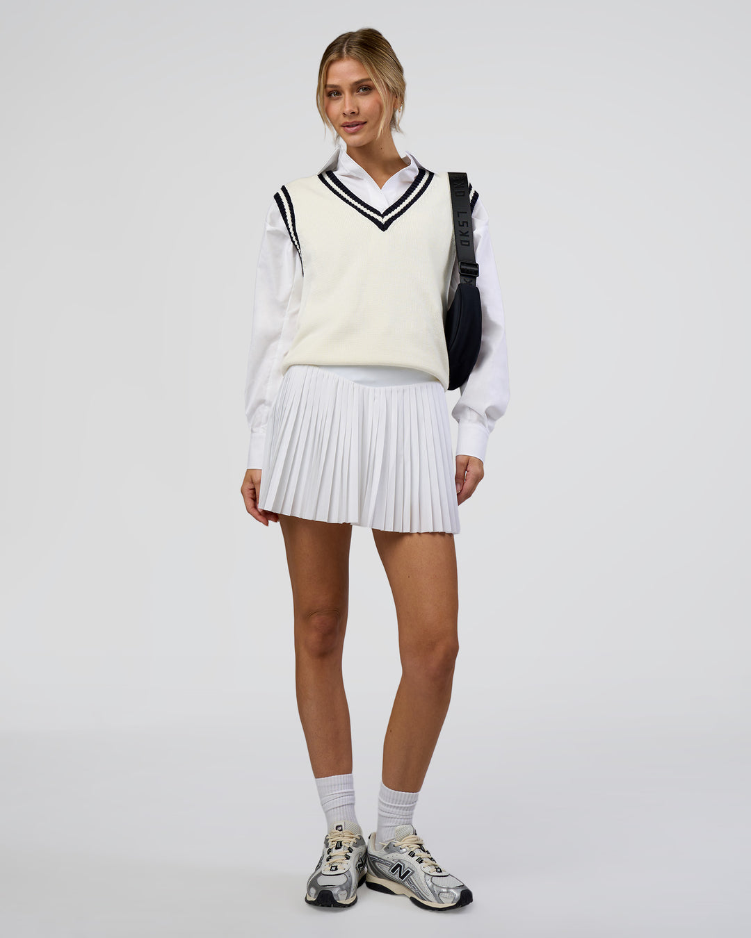 Woman wearing Clubhouse Vest - Off White-Future Navy | Model:Leilani | Size:XS