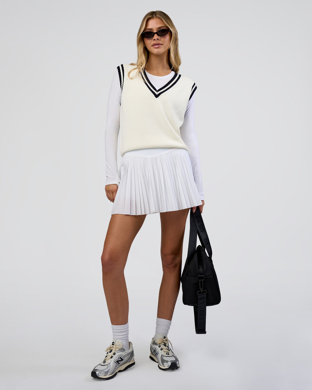 Woman wearing Clubhouse Vest - Off White-Future Navy | Model:Leilani | Size:XS