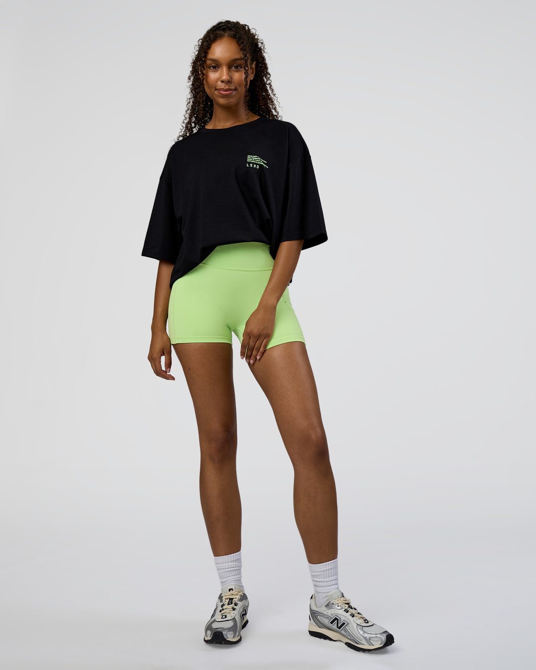 Woman wearing Coffee Run FLXCotton Oversized Tee - Black-Solar Lime | Model:Jordan | Size:L