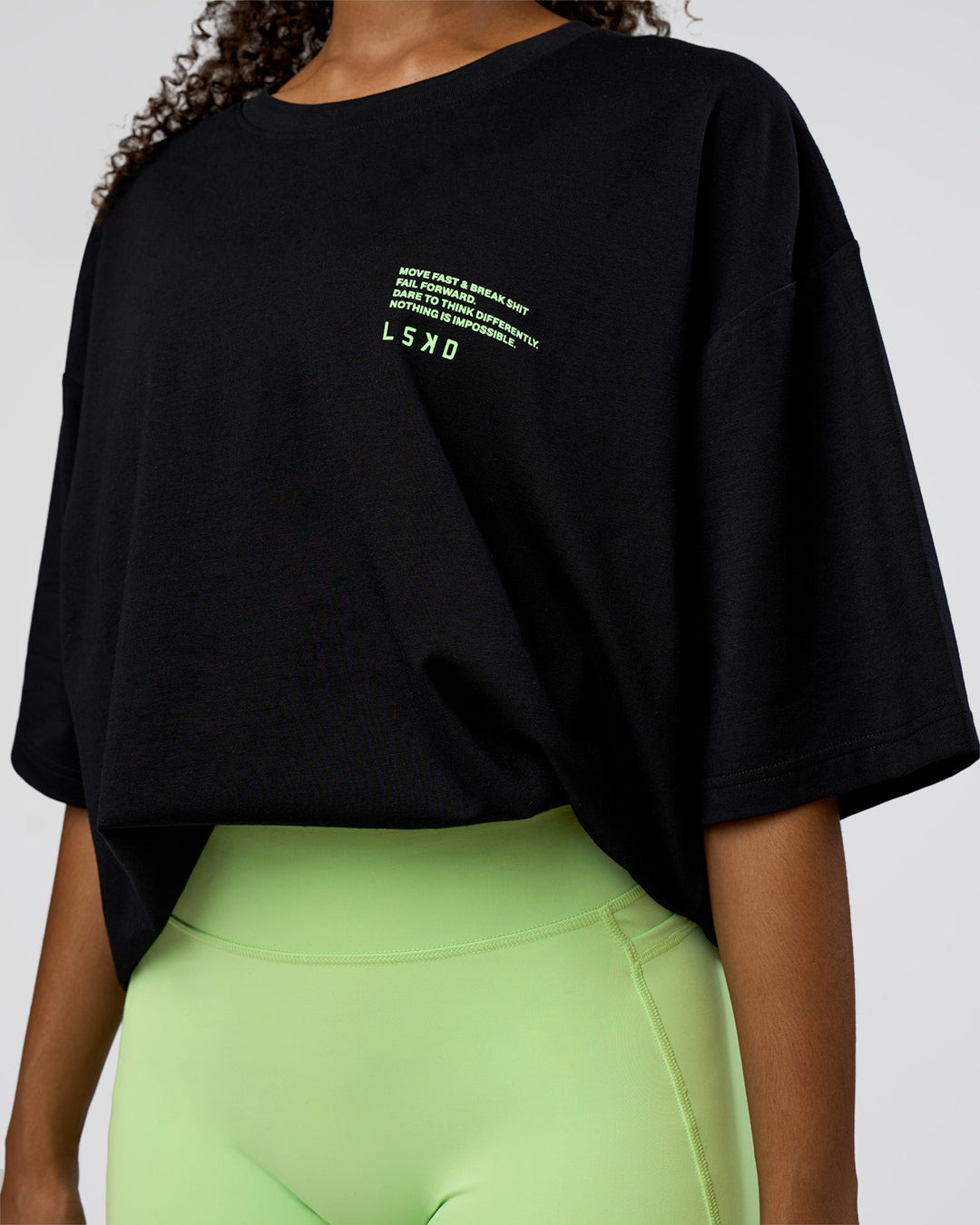 Woman wearing Coffee Run FLXCotton Oversized Tee - Black-Solar Lime | Model:Jordan | Size:L