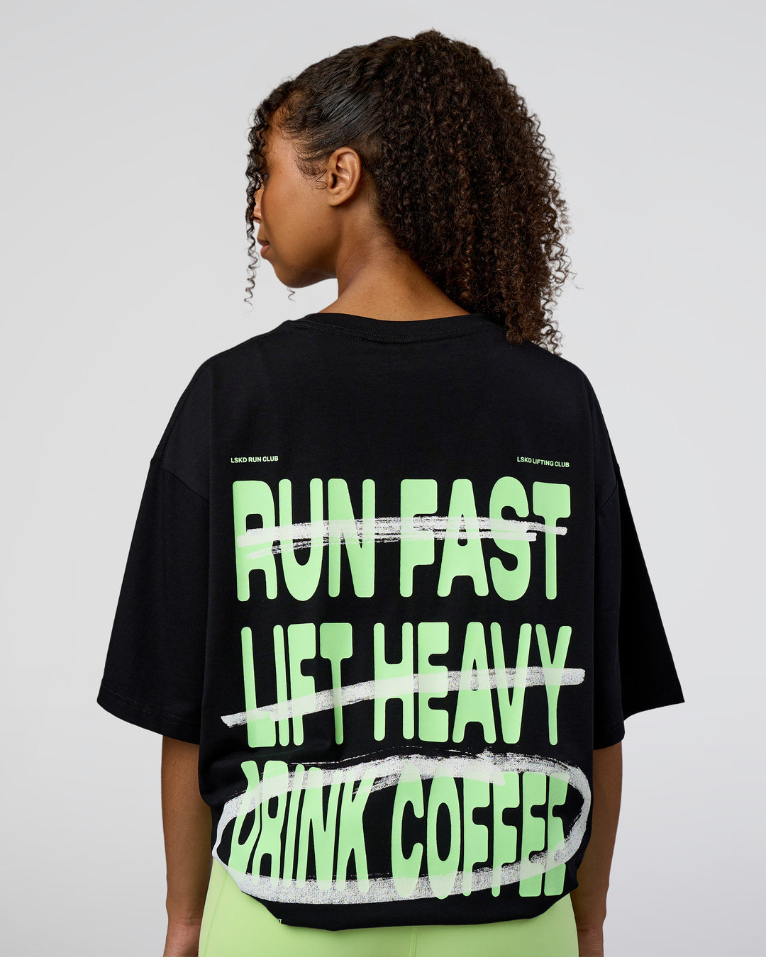 Woman wearing Coffee Run FLXCotton Oversized Tee - Black-Solar Lime | Model:Jordan | Size:L
