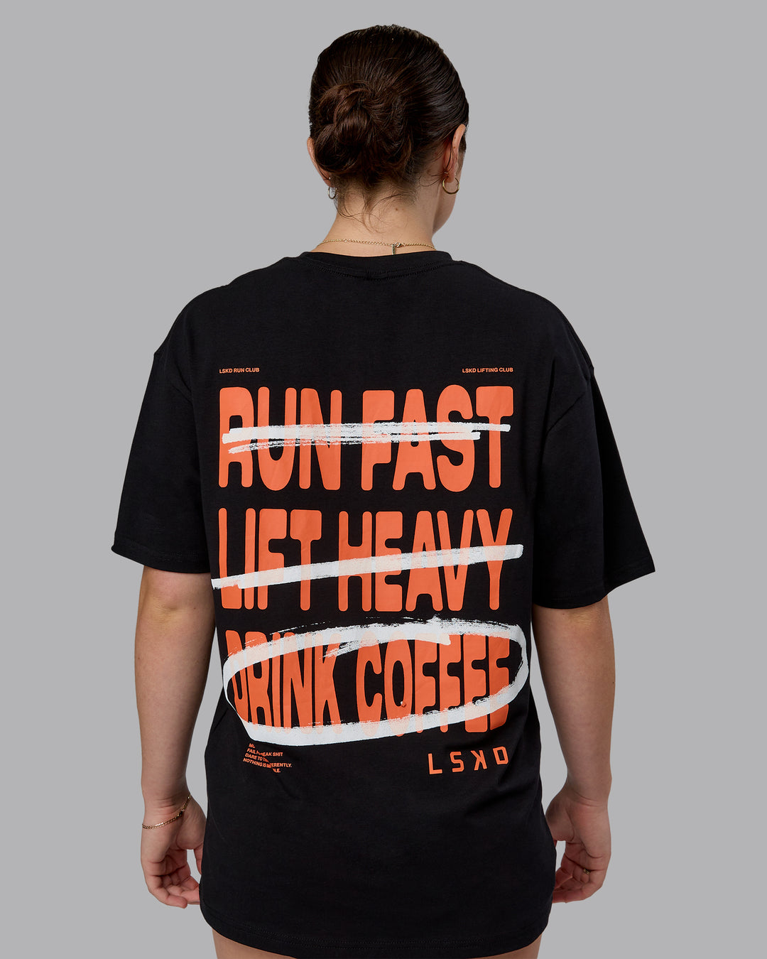 Woman wearing Coffee Run FLXCotton Oversized Tee - Black-Ultra Orange | Model:Sav | Size:XS
