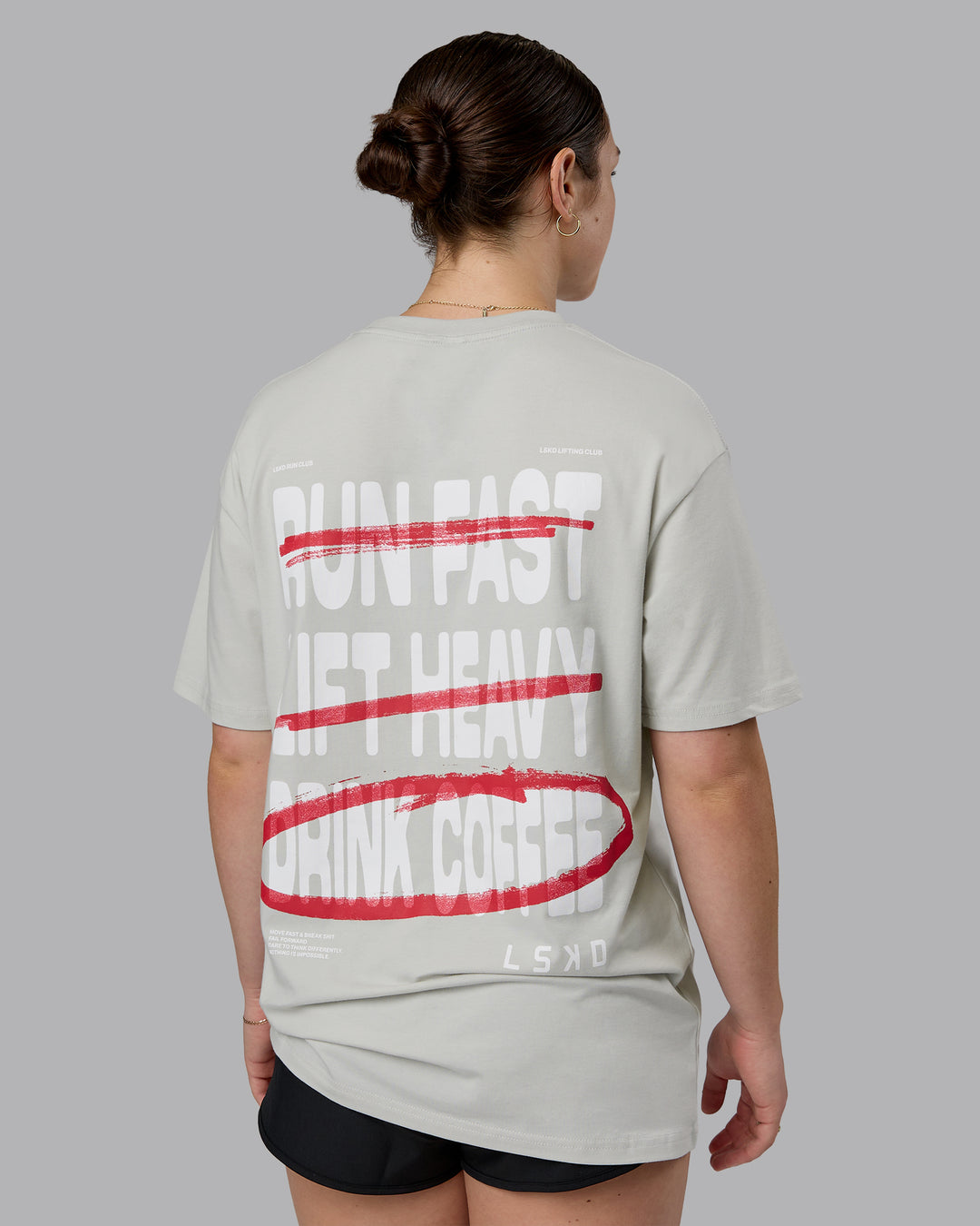 Woman wearing Coffee Run FLXCotton Oversized Tee - Digital Mist-Scarlet | Model:Sav | Size:XS