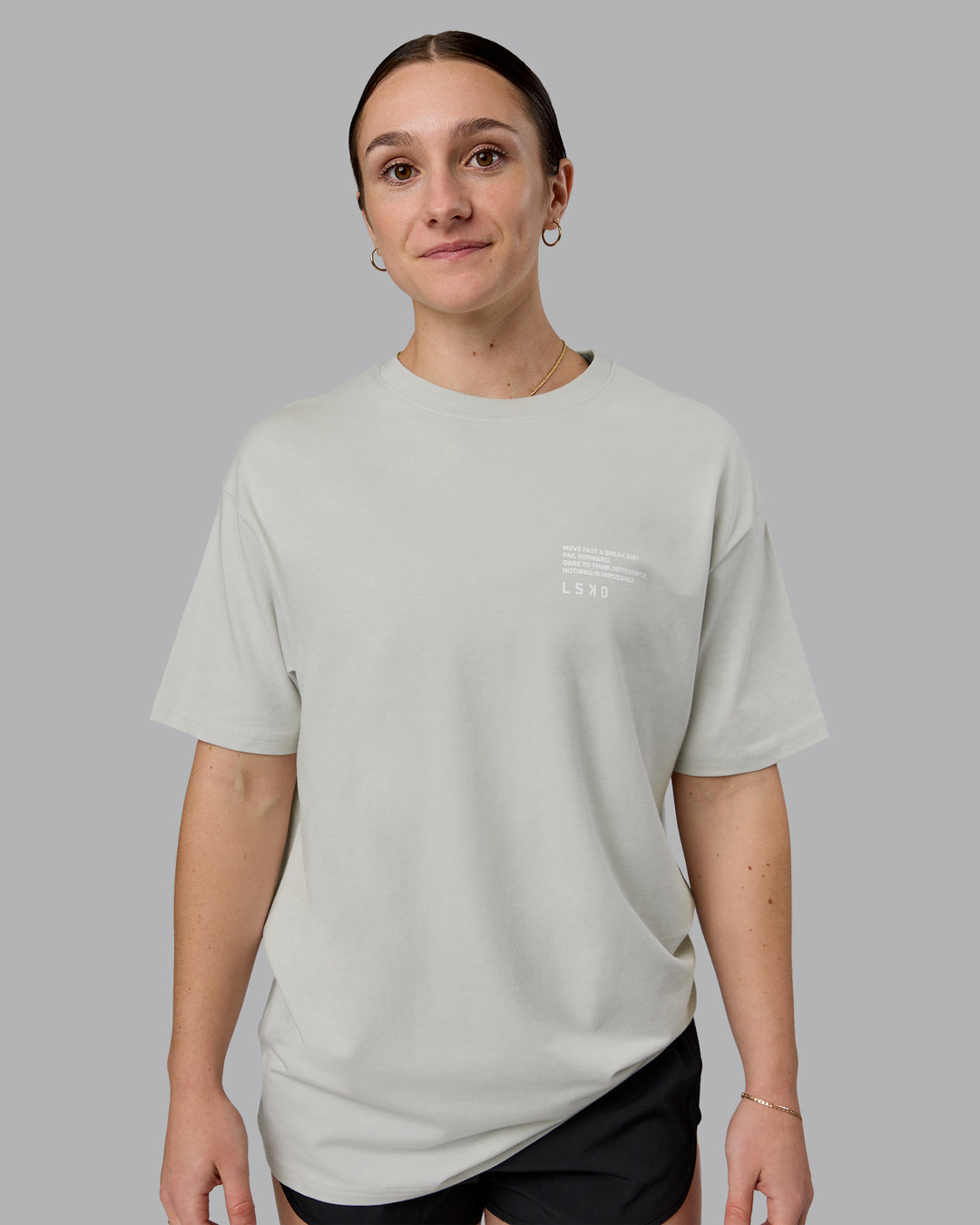 Woman wearing Coffee Run FLXCotton Oversized Tee - Digital Mist-Scarlet | Model:Sav | Size:XS