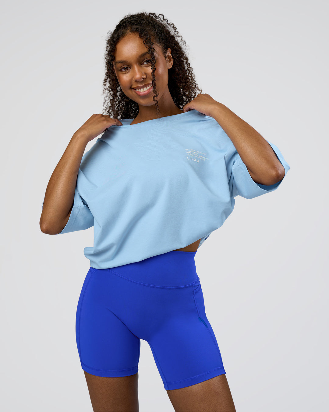 Woman wearing Coffee Run FLXCotton Oversized Tee - Open Air-White | Model:Jordan | Size:L