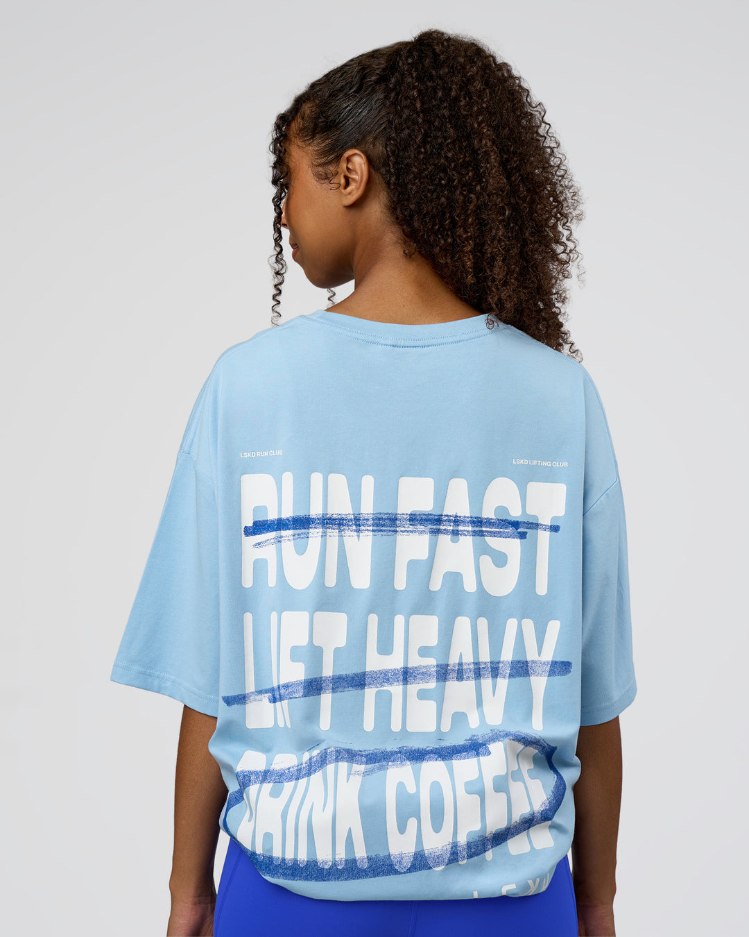 Woman wearing Coffee Run FLXCotton Oversized Tee - Open Air-White | Model:Jordan | Size:L