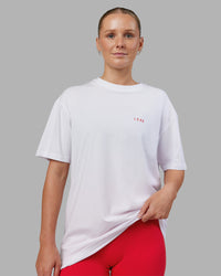 Woman wearing Dare To Think FLXCotton Tee Oversize - White-Scarlet | Model:Neve | Size:XS