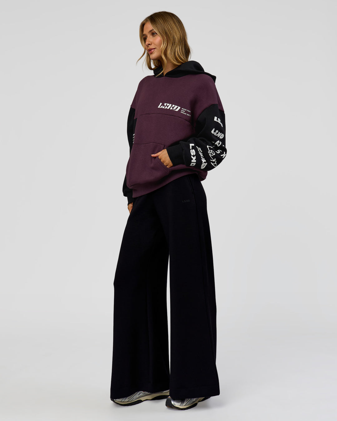 Woman wearing Deconstructed Fleece Hoodie - Caviar-Midnight Plum | Model:Leilani | Size:XS