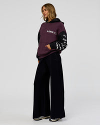Woman wearing Deconstructed Fleece Hoodie - Caviar-Midnight Plum | Model:Leilani | Size:XS