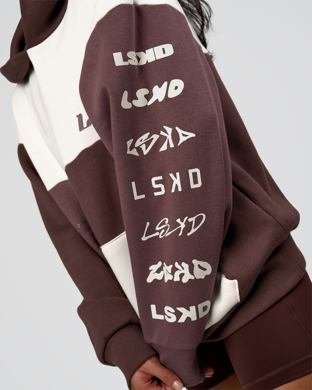 Woman wearing Deconstructed Fleece Hoodie - Off White-Cocoa Powder-Choc | Model:Loren | Size:XS