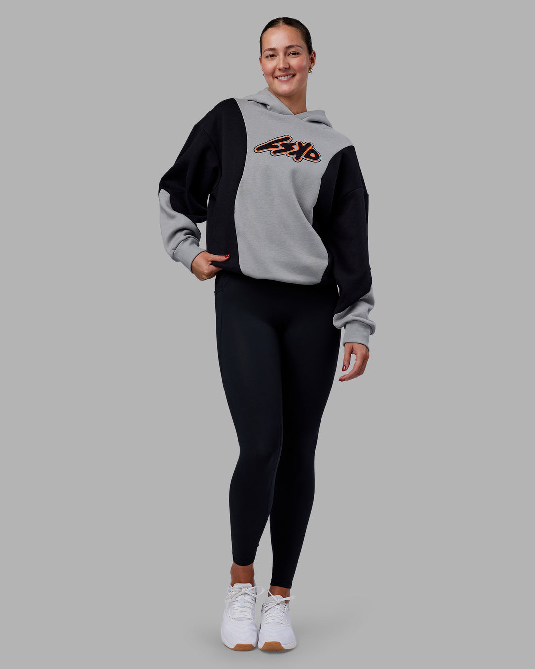 Woman wearing Downtown Oversized Panel Hoodie - Circular Grey - Black | Model:Remmi | Size:XS