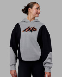 Woman wearing Downtown Oversized Panel Hoodie - Circular Grey - Black | Model:Remmi | Size:XS