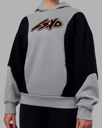 Woman wearing Downtown Oversized Panel Hoodie - Circular Grey - Black | Model:Remmi | Size:XS