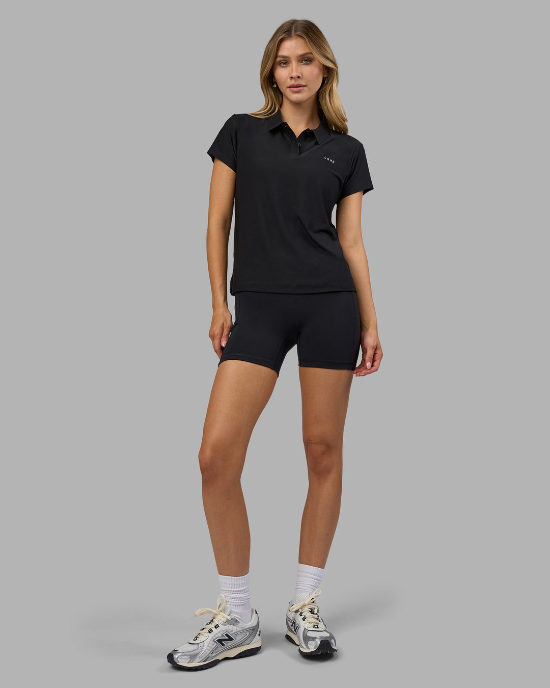 Woman wearing Drive Polo - Black | Model:Leilani| Size:XS