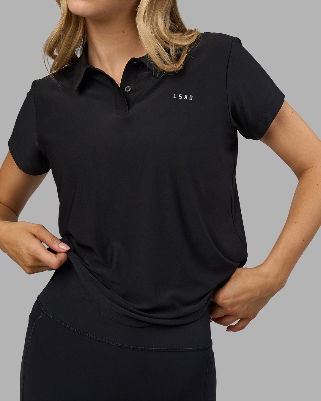 Woman wearing Drive Polo - Black | Model:Leilani| Size:XS