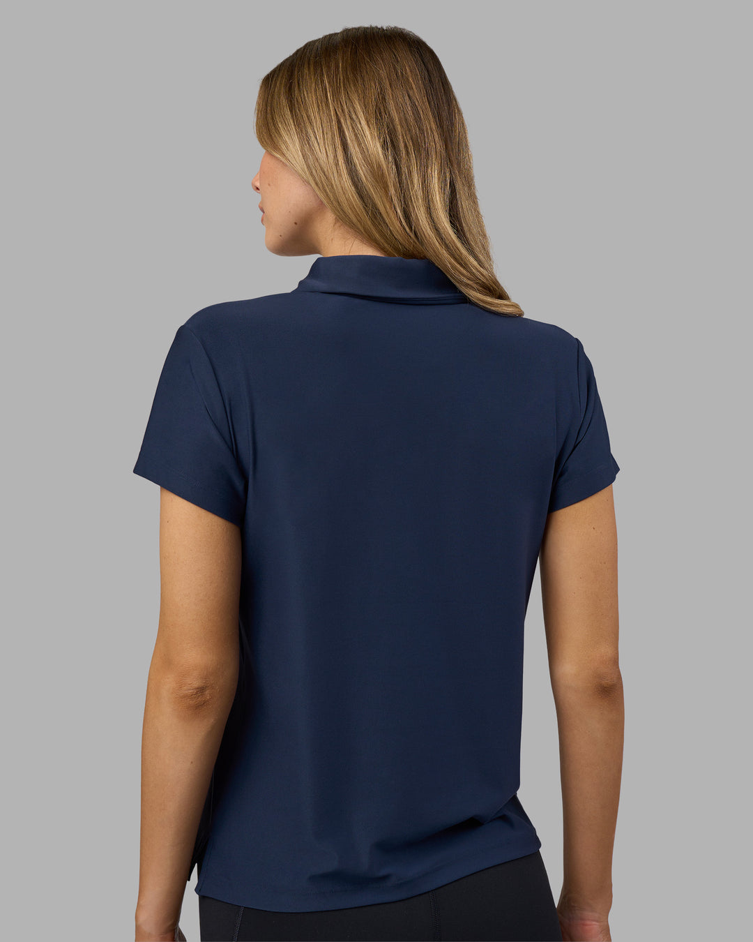 Woman wearing Drive Polo - Future Navy | Model:Leilani | Size:XS