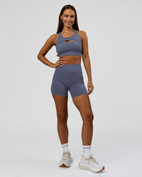 Woman wearing Elite Run High-Rise 5" Short Pockets - Night Shadow | Model:Brylee | Size:XS