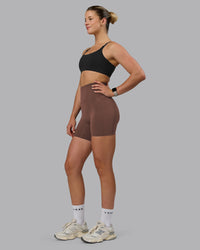 Woman wearing Elixir Ultra High-Rise 6" Short Pockets - Chocolate Martini | Model:Chloe | Size:XS