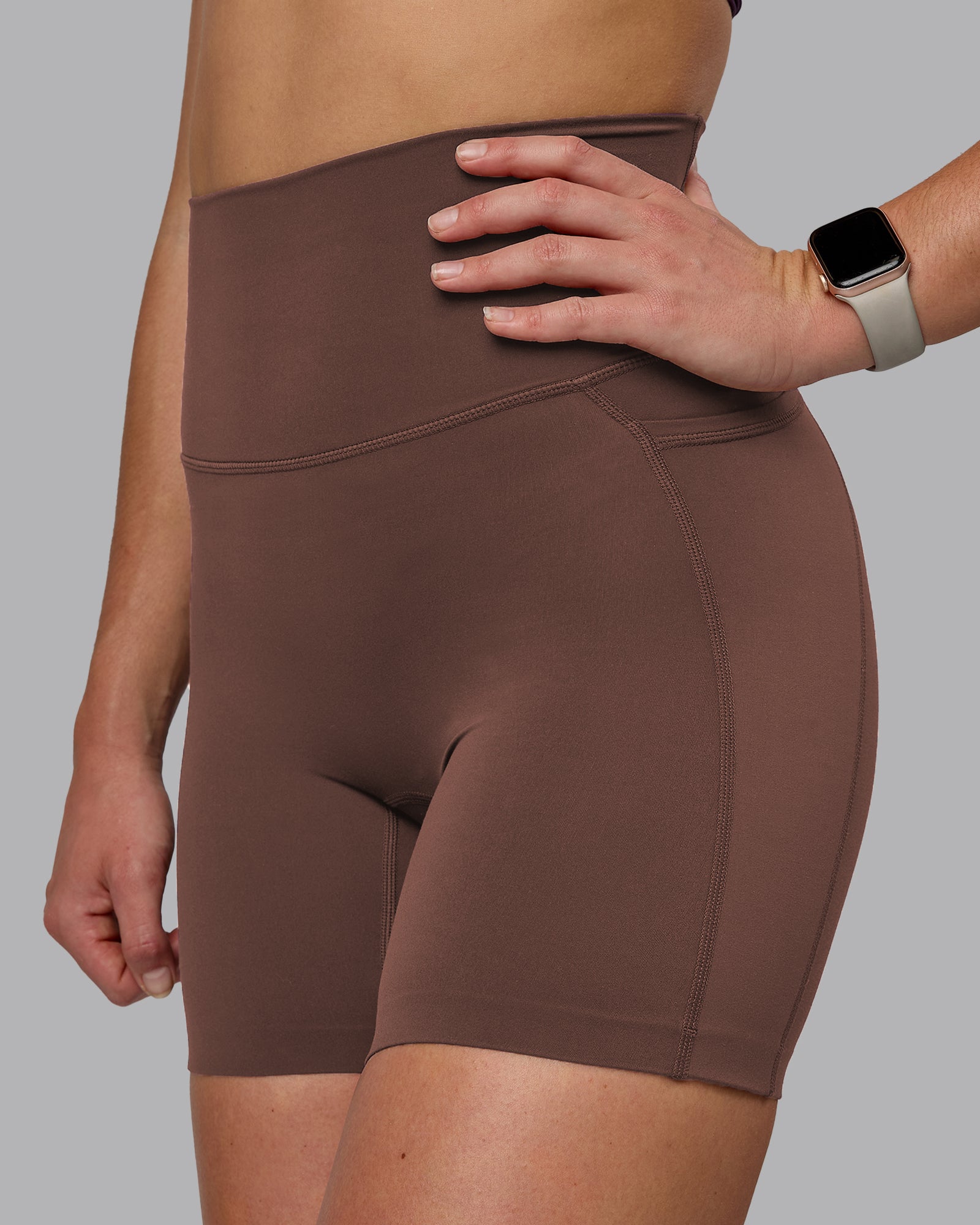 Woman wearing Elixir Ultra High-Rise 6" Short Pockets - Chocolate Martini | Model:Chloe | Size:XS