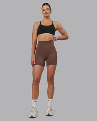 Woman wearing Elixir Ultra High-Rise 6" Short Pockets - Chocolate Martini | Model:Chloe | Size:XS