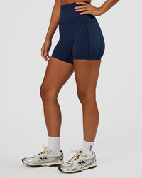 Woman wearing Elixir Ultra High-Rise 4" Short Pockets - Future Navy | Model:Brylee | Size:XS