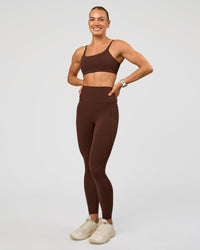 Woman wearing Elixir Ultra High-Rise Full Length Legging Pockets - Hot Chocolate | Model:Maja | Size:XS